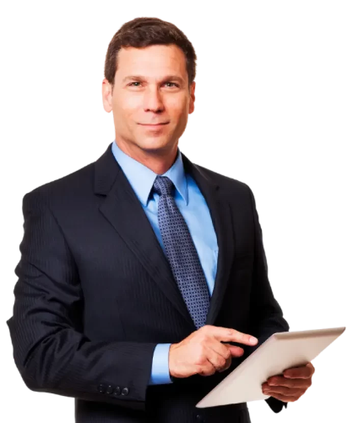 A man in a suit holds a tablet and smiles confidently at the camera.